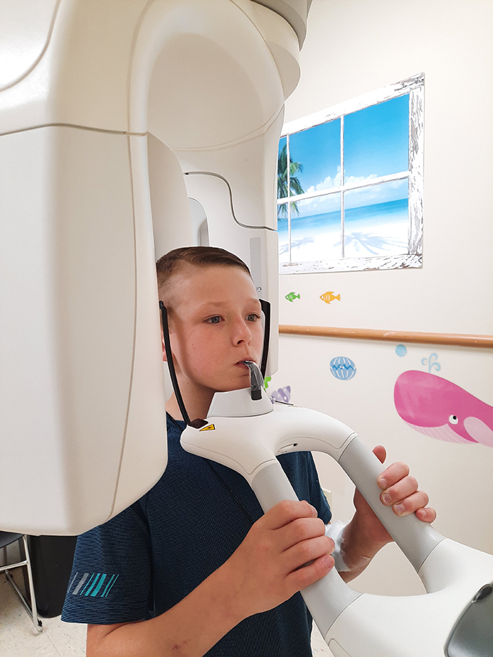 A young dental clinic patient experiencing the panoramic X-ray